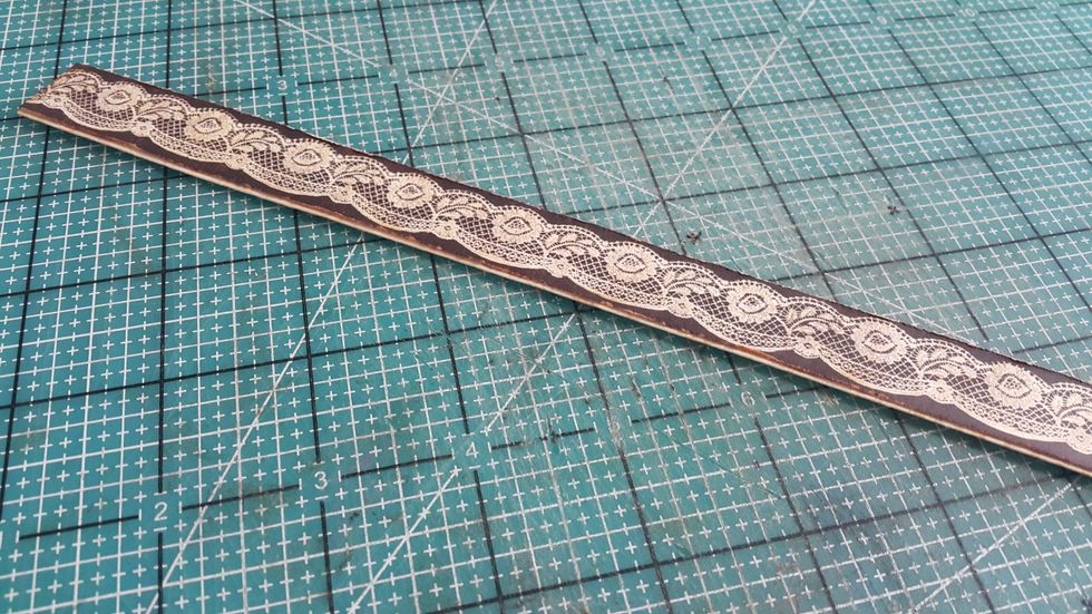 Cut the lace pattern from paper and adhere on the handle strips