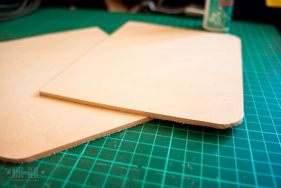 Cut the leather in half. We\u2019\u0080\u0099ll later insert a piece of thinner leather as a spine.