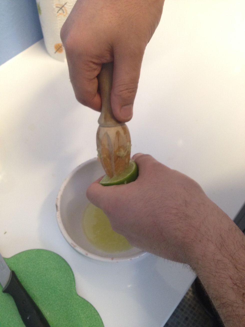 Cut the limes in half and start to juice