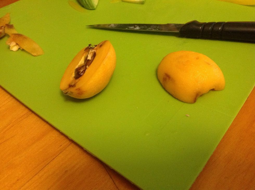Cut the loquats in half and cut out the top and bottom bits and peel and slice into strips.