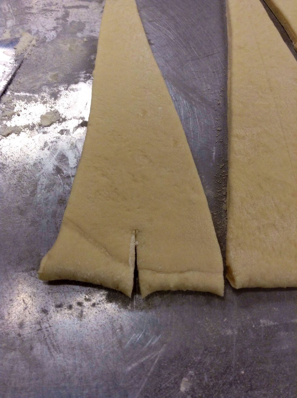 Cut the middle of the bottom of the croissant about 3/4ths of an inch.