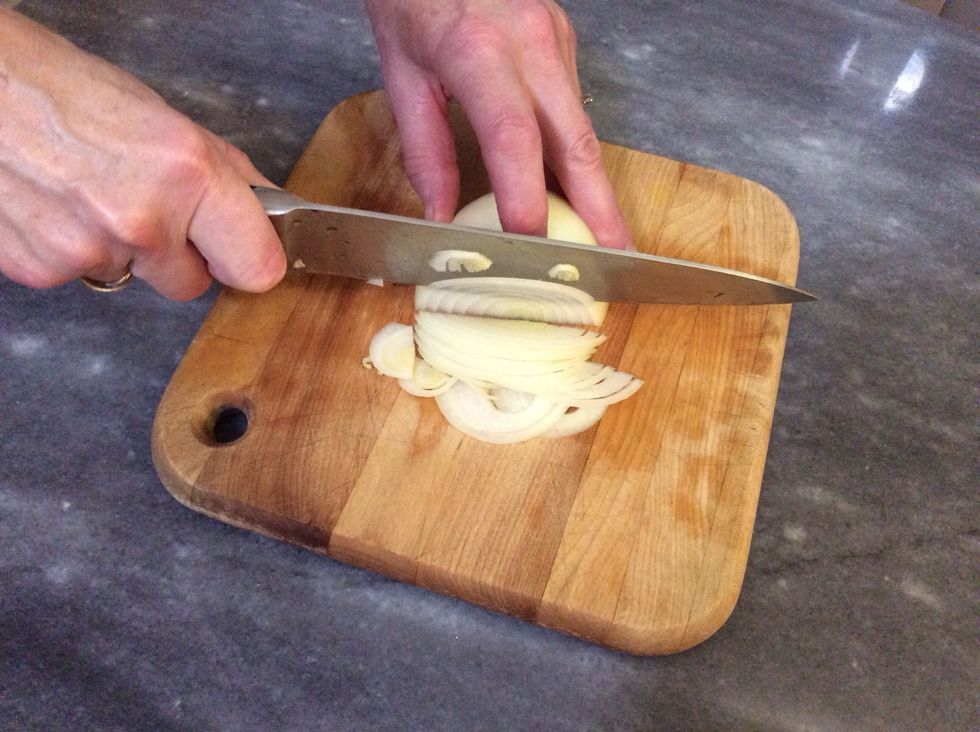 Cut the onion in half and slice crosswise into very thin slices.
