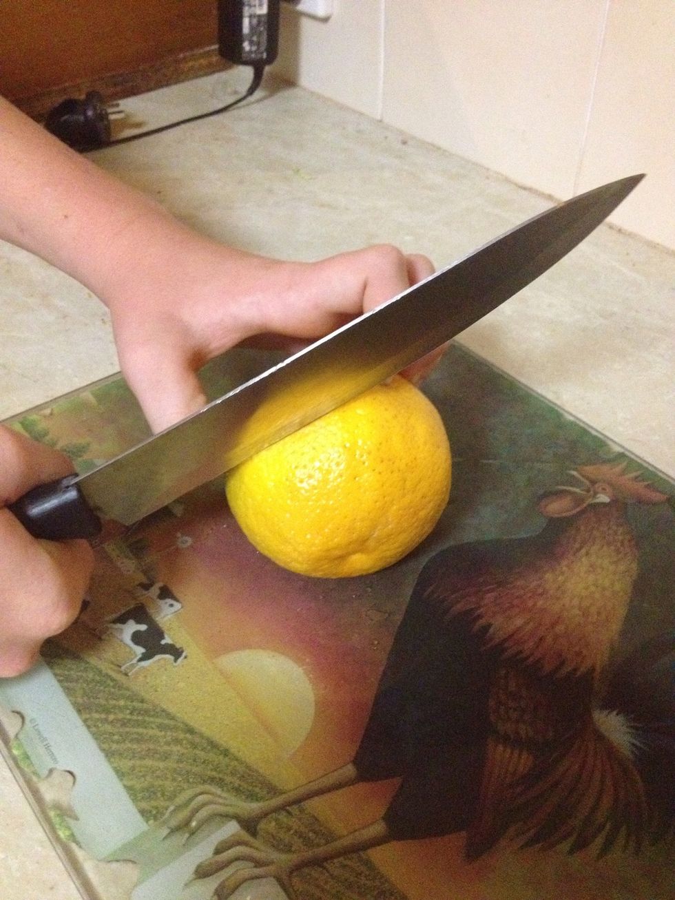 Cut the orange in half side to side. (not head to bottom)