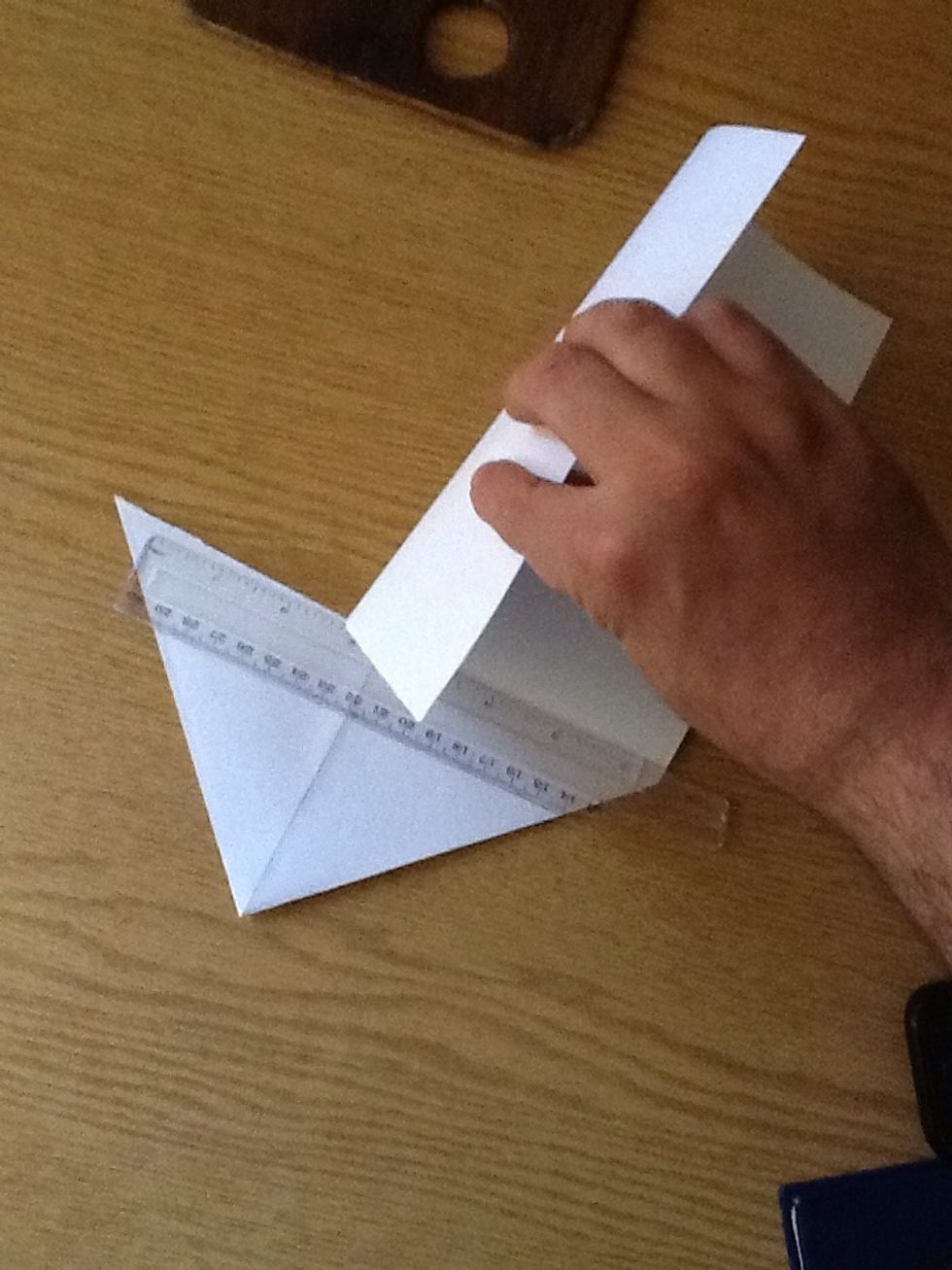 Cut the paper following the fold you just made along its base.. Using a ruler can be handy..
