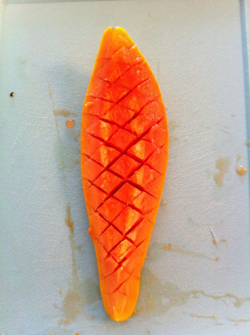 Cut the Pawpaw diagonally both ways as shown in the Photo. Tip: Use a blunt table setting knife to avoid cutting through the Skin.