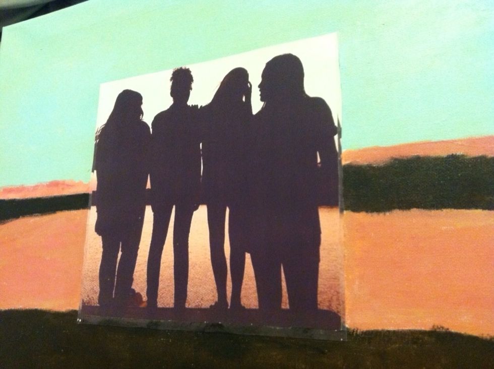 Cut the picture and Mod Podge the copy to the center of the canvas. Using a paper plate, mix the color until you have an exact match.