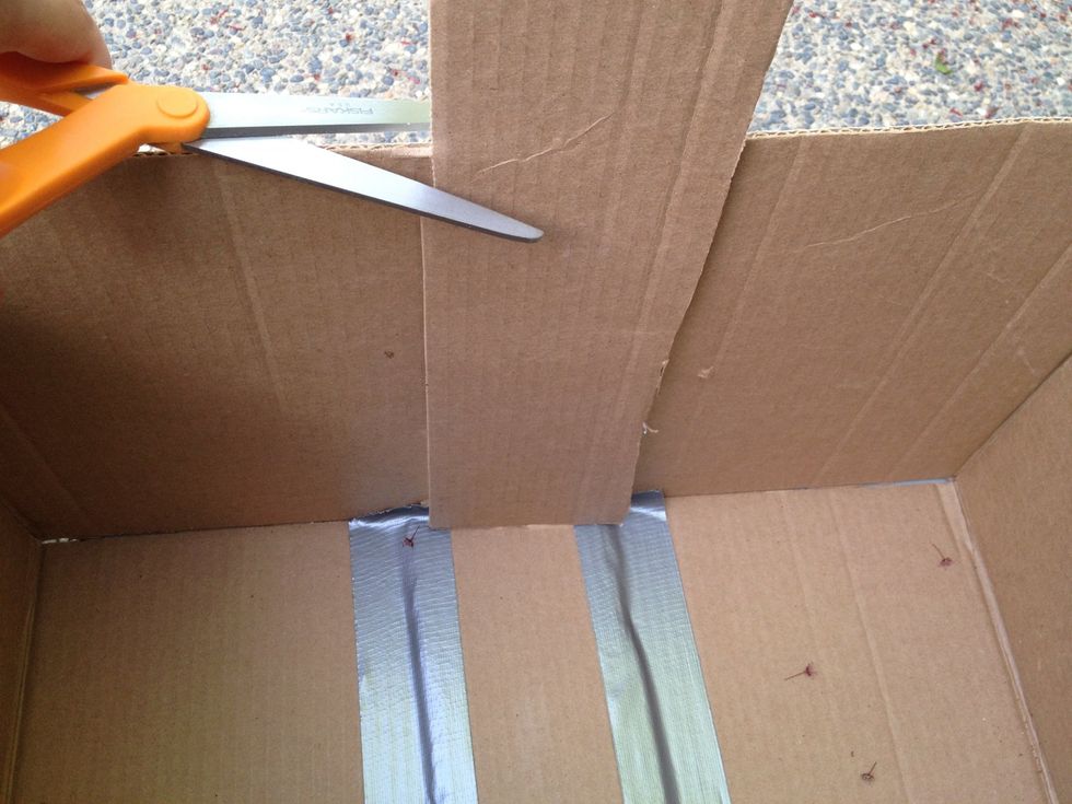 Cut the piece that extends past the top of the box.