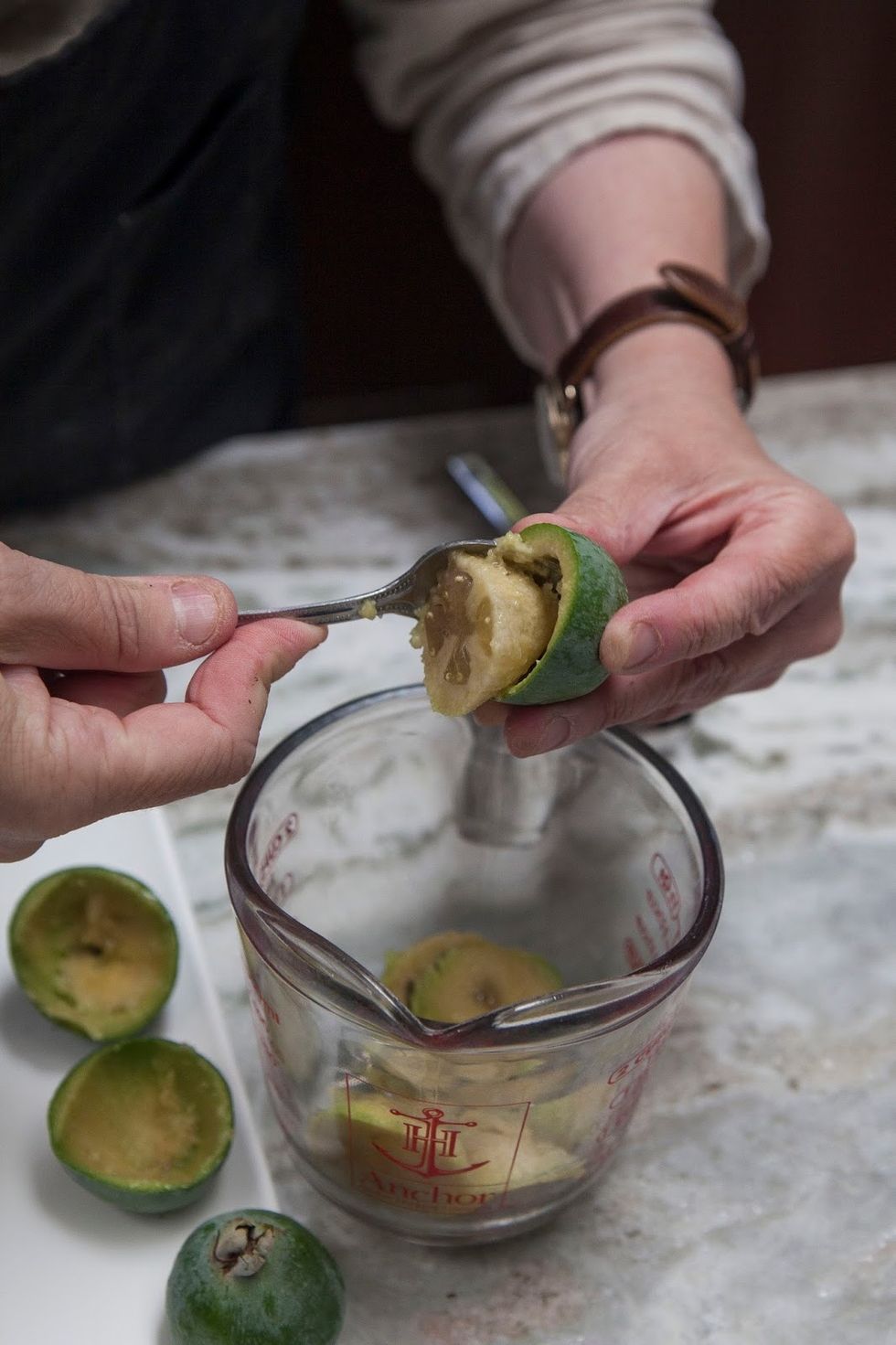 Cut the pineapple guavas in half and scoop out the meat.