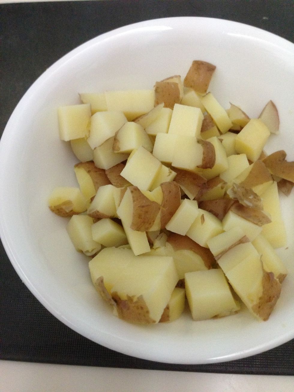 Cut the potatoes into cubes. Add olive oil and salt