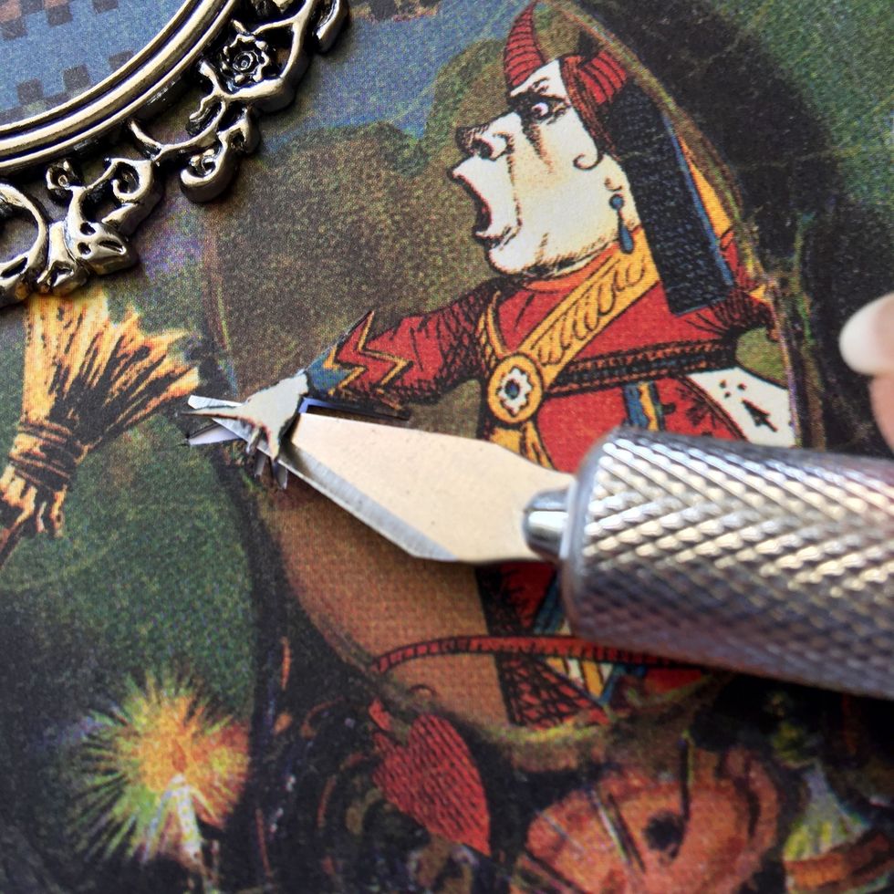 Cut the queen's hand as shown of the other equal piece of paper.