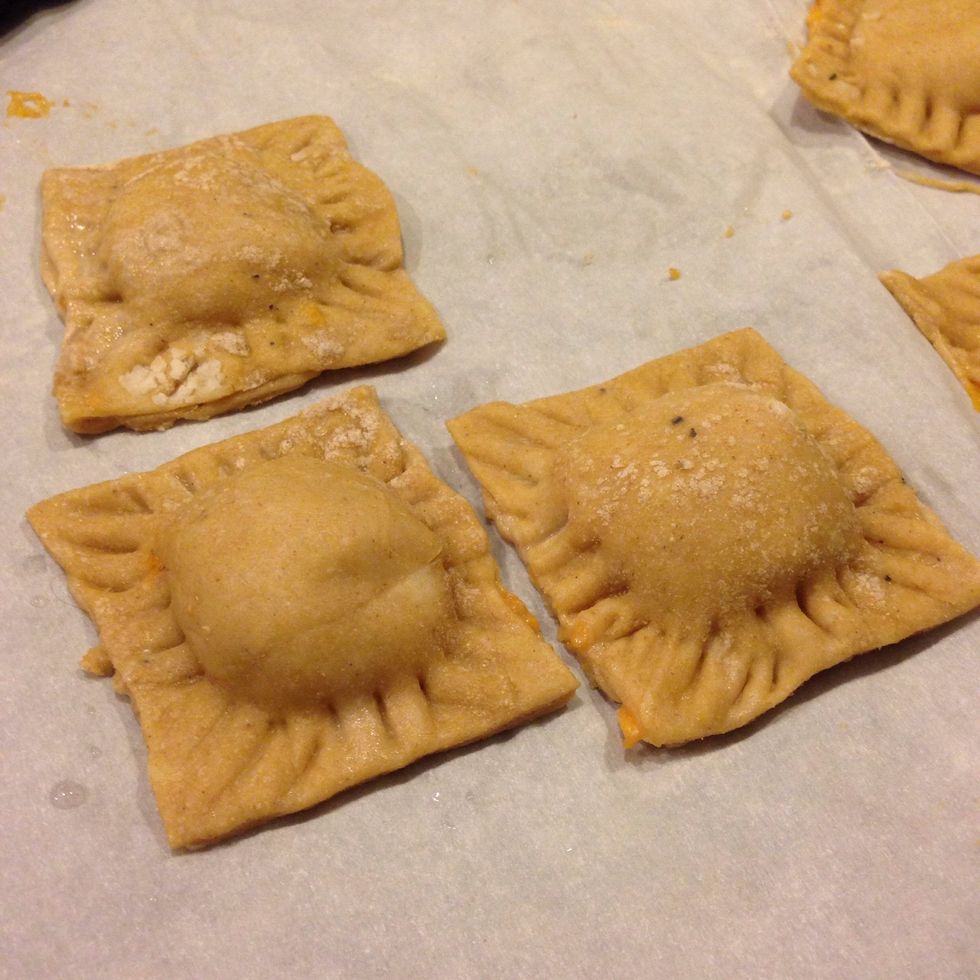 Cut the ravioli out with a pizza roller (or knife, doesn't matter!) and use a fork to bind the edges together- like you would do with pie crust.