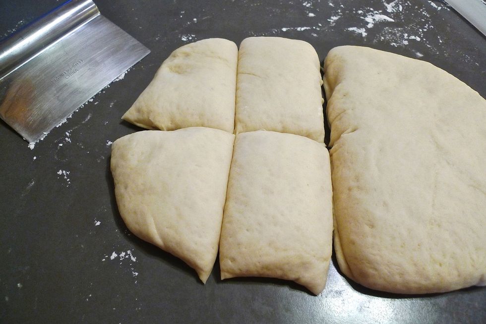 Cut the rectangular dough in half. Cut each half into 4 equal pieces. One half to make hamburger buns. The other half to make hot dog buns. ( Or make all 8 hamburger buns or 8 hot dog buns )