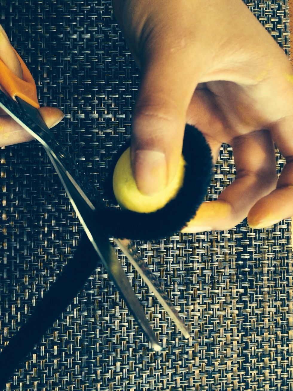 Cut the rest off and stab it in to the ball to secure the pipe cleaner.