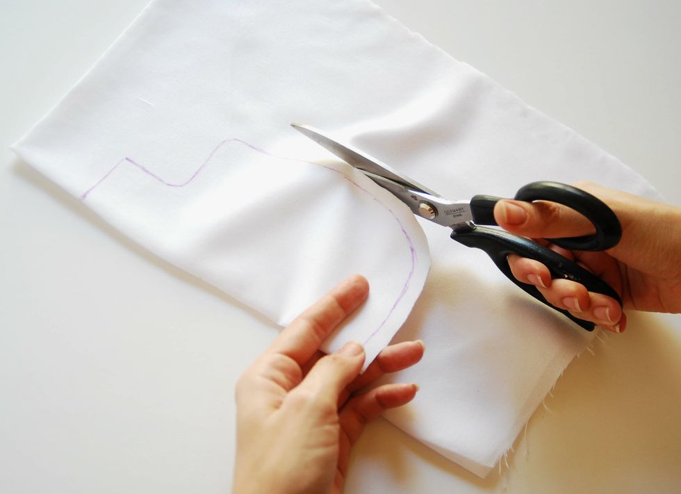 Cut the selected shape with scissors leaving 1 cm wide margins sewing from the contour. Prepared two identical pieces of cotton for the inside Pillowcase of the pillow