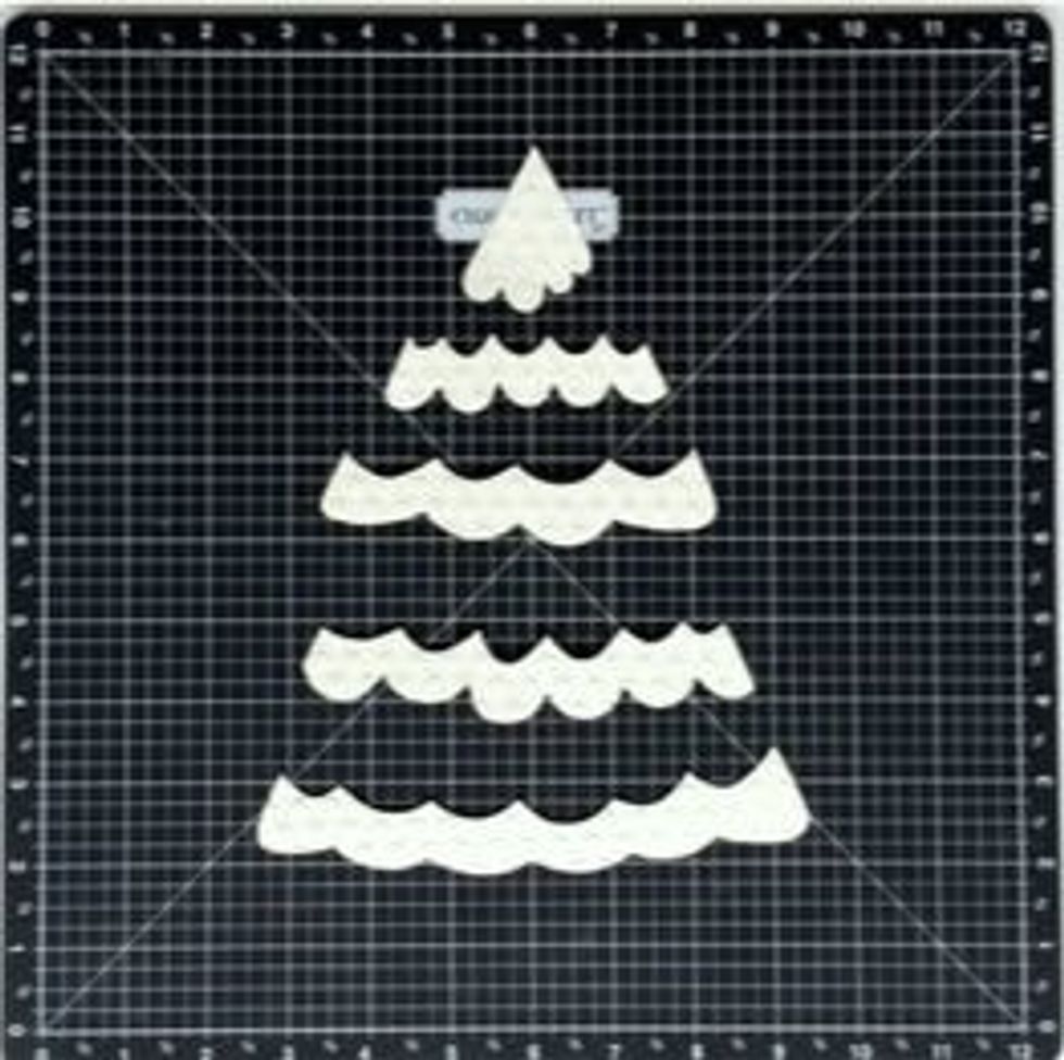 Cut the snow sections out of Colonial White Paper using the template. Use the Dot Embossing folder to create texture on these pieces to make them pop. Ink distress.