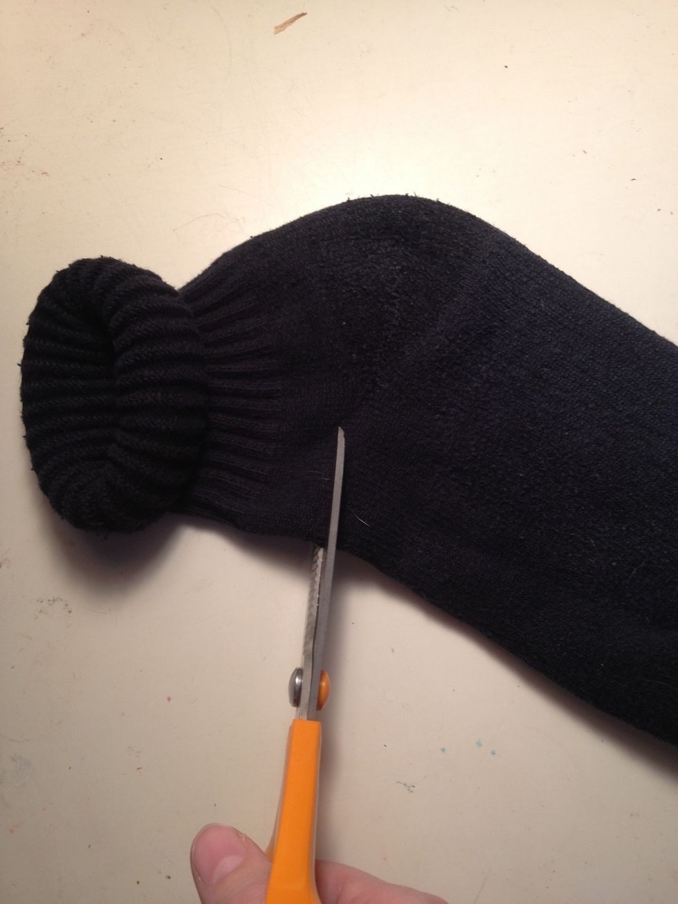 Cut the sock off just above the heel