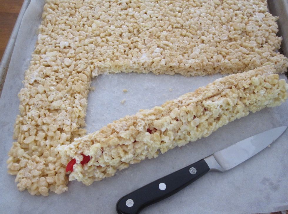 Cut the solid pan of Rice Krispie Treats into the size desired. 2 by 2 inch squares are recommended.