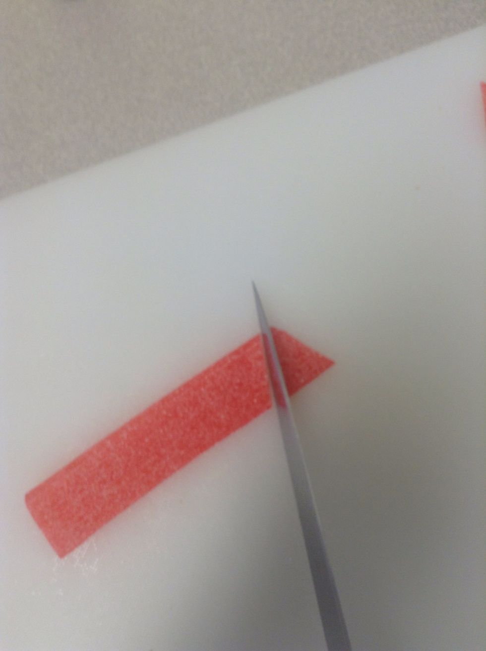 Cut the sour straps into triangles, around 1cm in length
