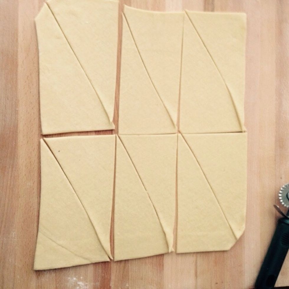 Cut the square in 2 on one edge and 3 on the other to get 6 equal rectangles. Cut each one on the diagonal to achieve 12 even rectangles
