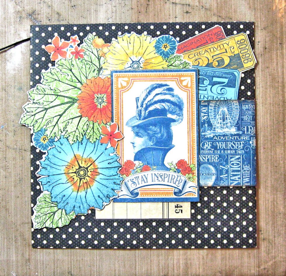 Cut the Stay Inspired image from 12 x 12 Wonder Works page. Back with foam dimensional.Tuck around flowers as seen here. ( Ignore the blue printed paper on the right. It was covered up in the end.)