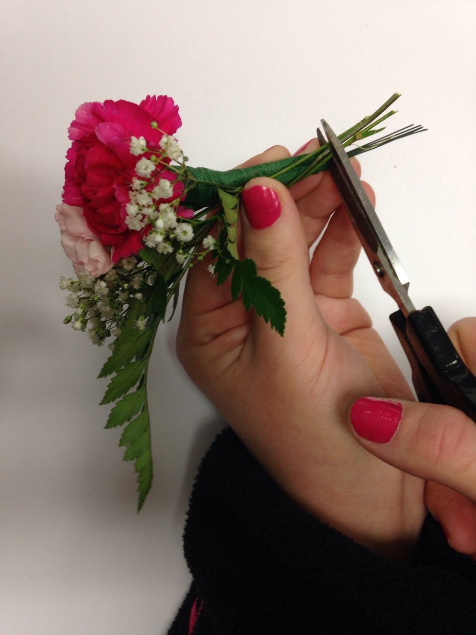 Cut the stems of bakers fern and baby's breath to the same length of the carnations.