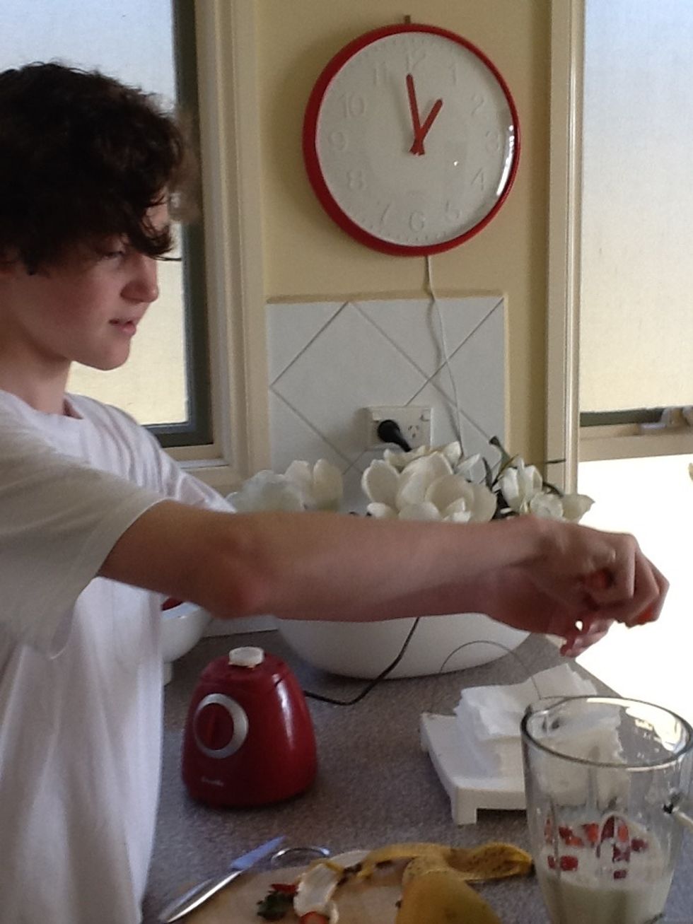 Cut the strawberries and put them into the blender.