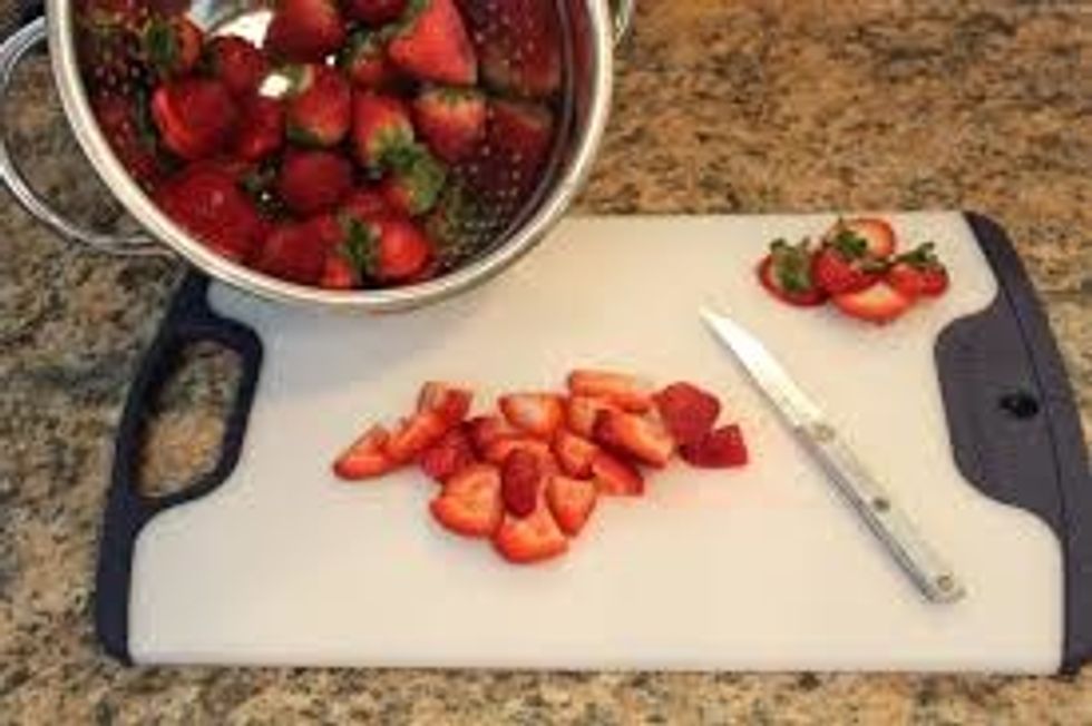 cut the strawberries into fourths and throw the top with the stem away