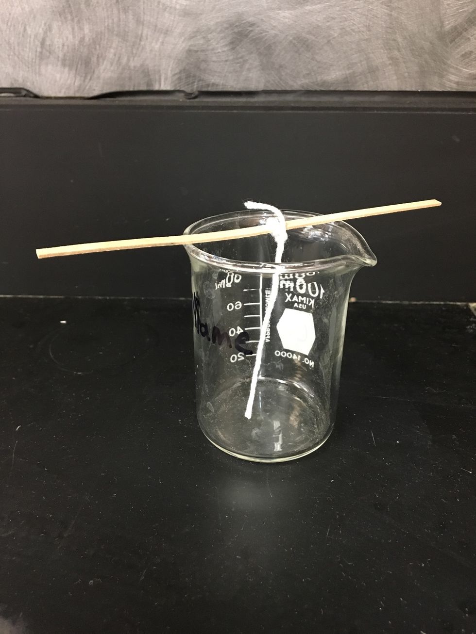 Cut the string so that it ends slightly above the bottom of the beaker.