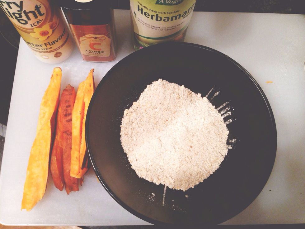 Cut the sweet potato into wedges. Put into bowl with fry light, processed oats and add spices that you like (I used Herbamare and cayenne pepper). Mix it together until all wedges are covered.