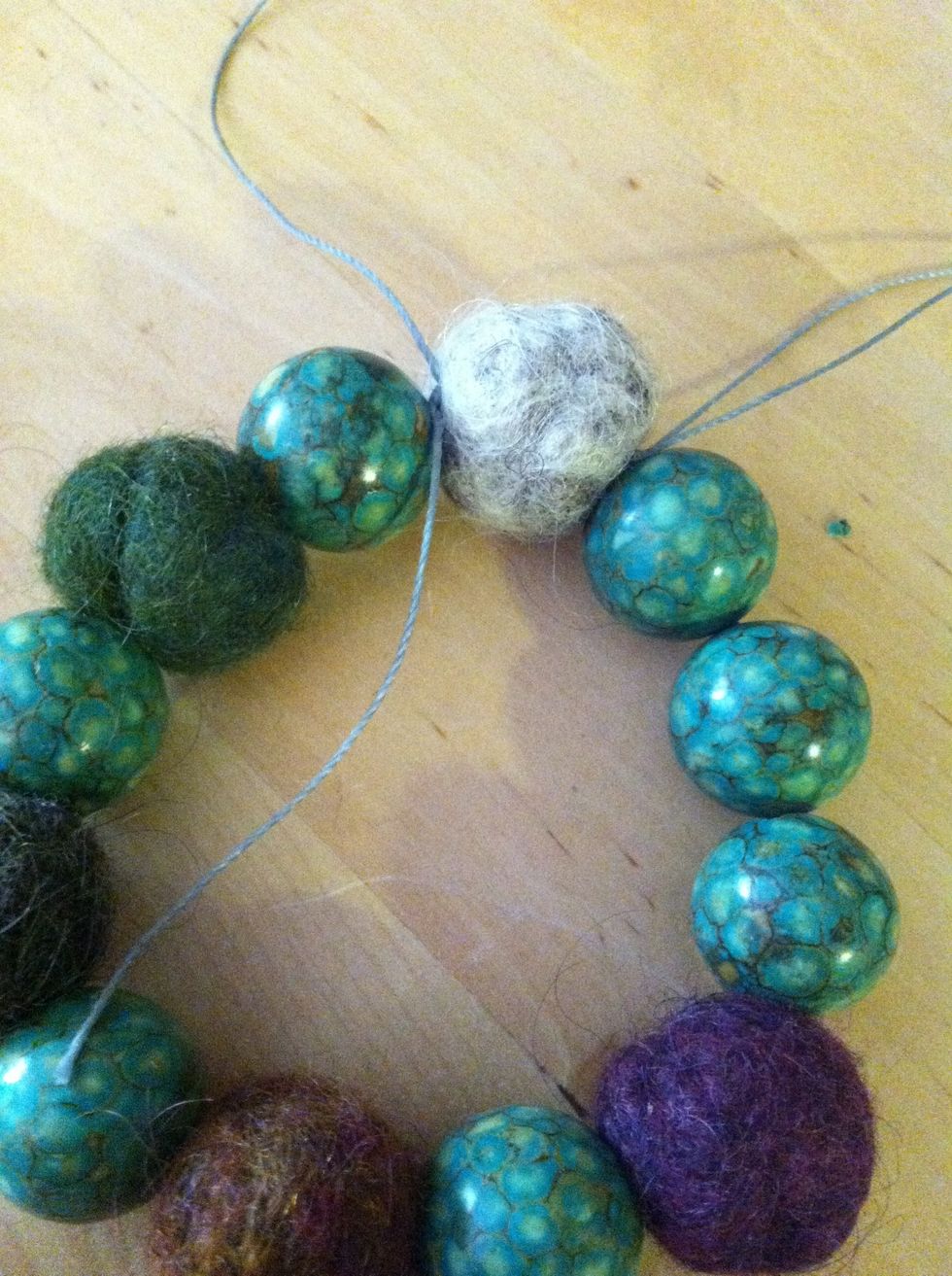 Cut the thread and remove the needle and repeat the knots on the other side.