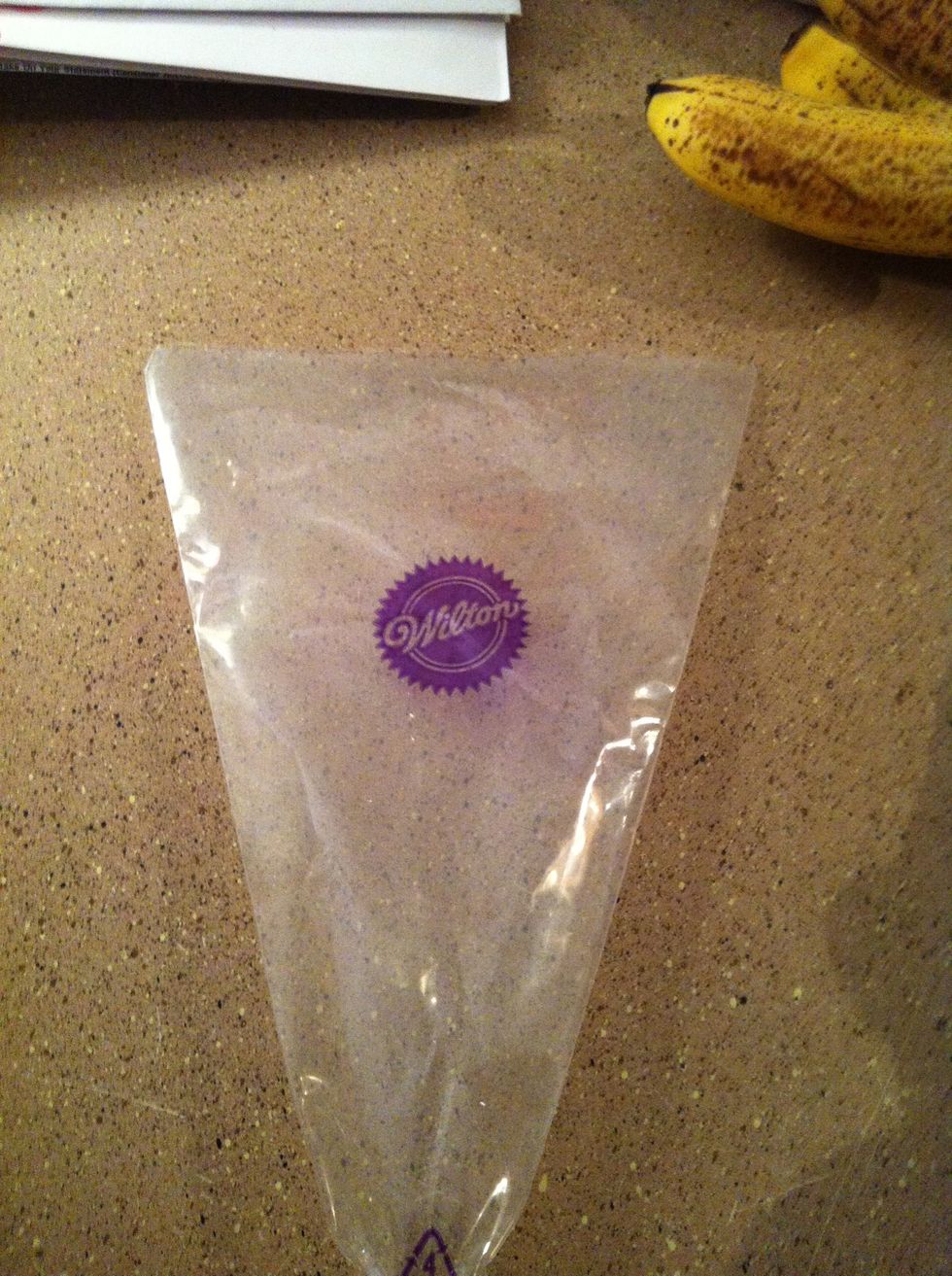 Cut the tip of your piping bag, but only enough for your piping tip to poke through.