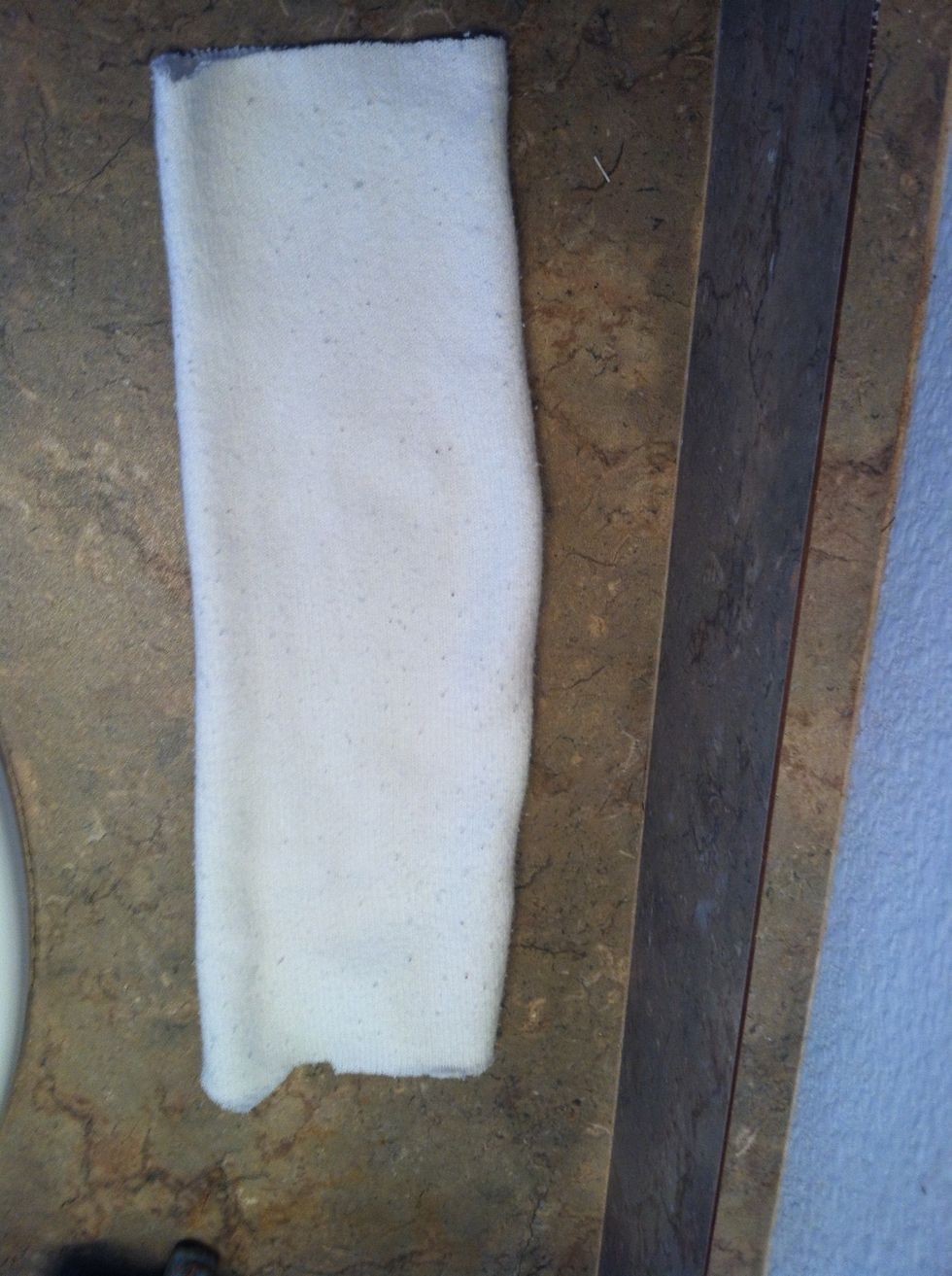 Cut the toe part off , I cut both ends since it was a super long tube sock
