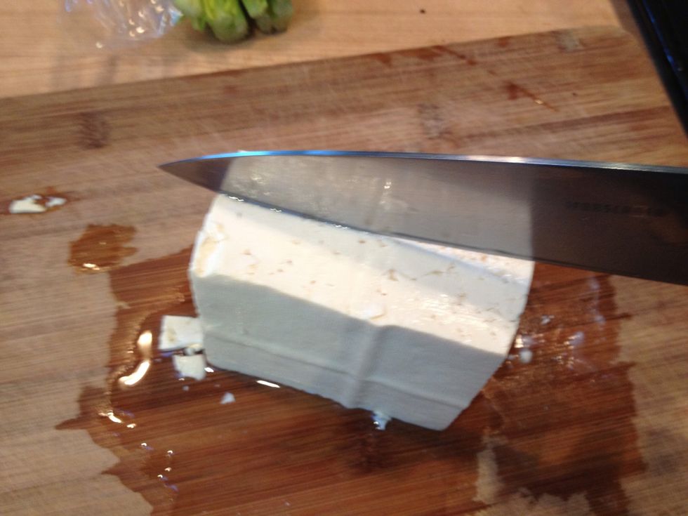 Cut the tofu into bite-sized rectangles. The chunks I am doing here are optimized for volume. 3 blocks of tofu fit on one pan. 1/4" flat slices are also good it you plan to make tofu sandwiches.