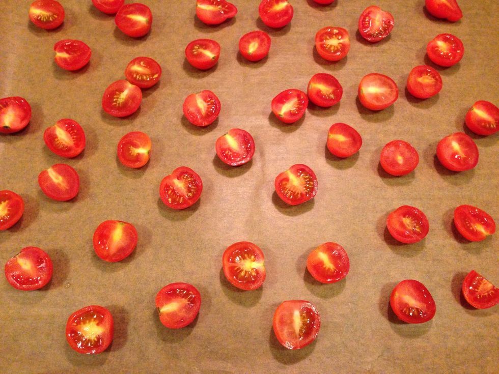 Cut the tomatoes and place them on a baking sheet.