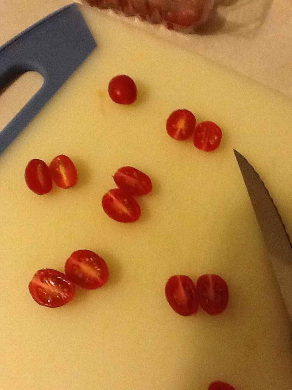 Cut the tomatoes in half. I have used grape tomatoes here, but cherry tomatoes are delicious too.