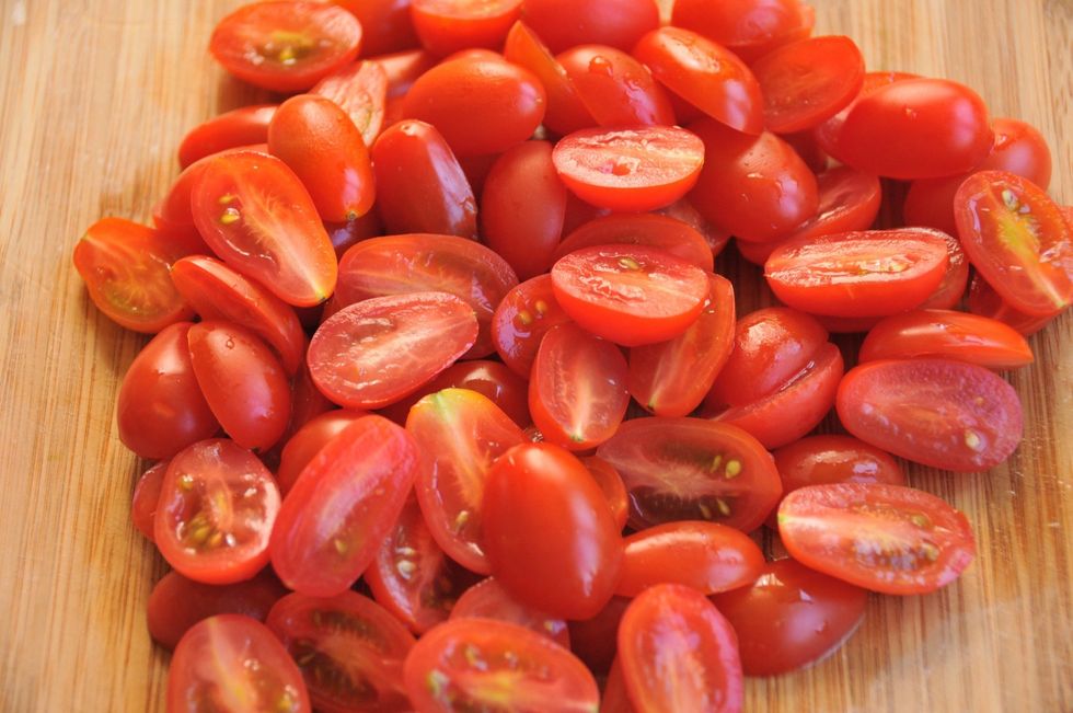 Cut the tomatoes in half then place in a large bowl.  If you want to add a bit more color to this dish, use yellow and red tomatoes.  Just make sure they are fresh and crisp.