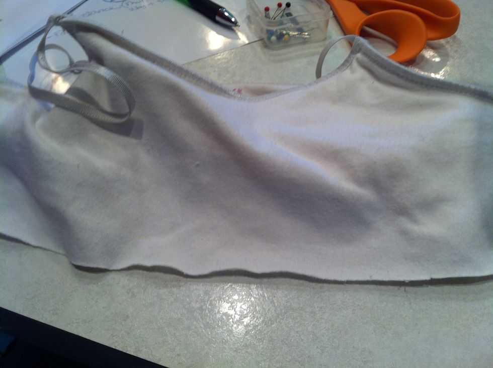 Cut the top 1/3 (somewhere around where your ribcage would be) off of a t-shirt or tank top, discard. The t-shirt must fit you snugly or the material won't hold up the pants properly later!