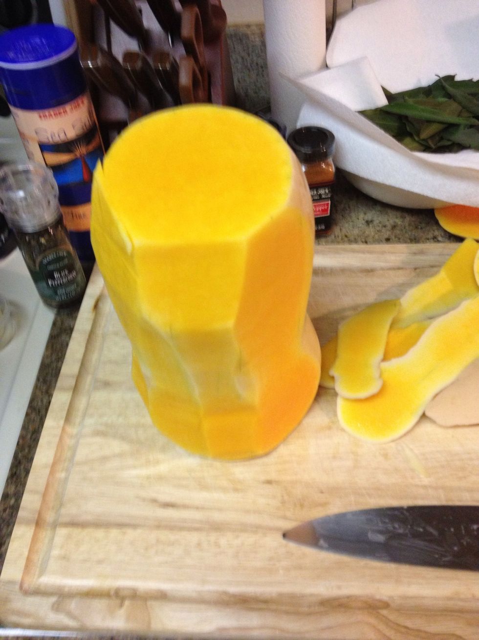 Cut the top and bottom off of the squash, stand it up and trim the skin of of the squash. Or you can peel it, but the skin is so thick you might have to peel it twice.