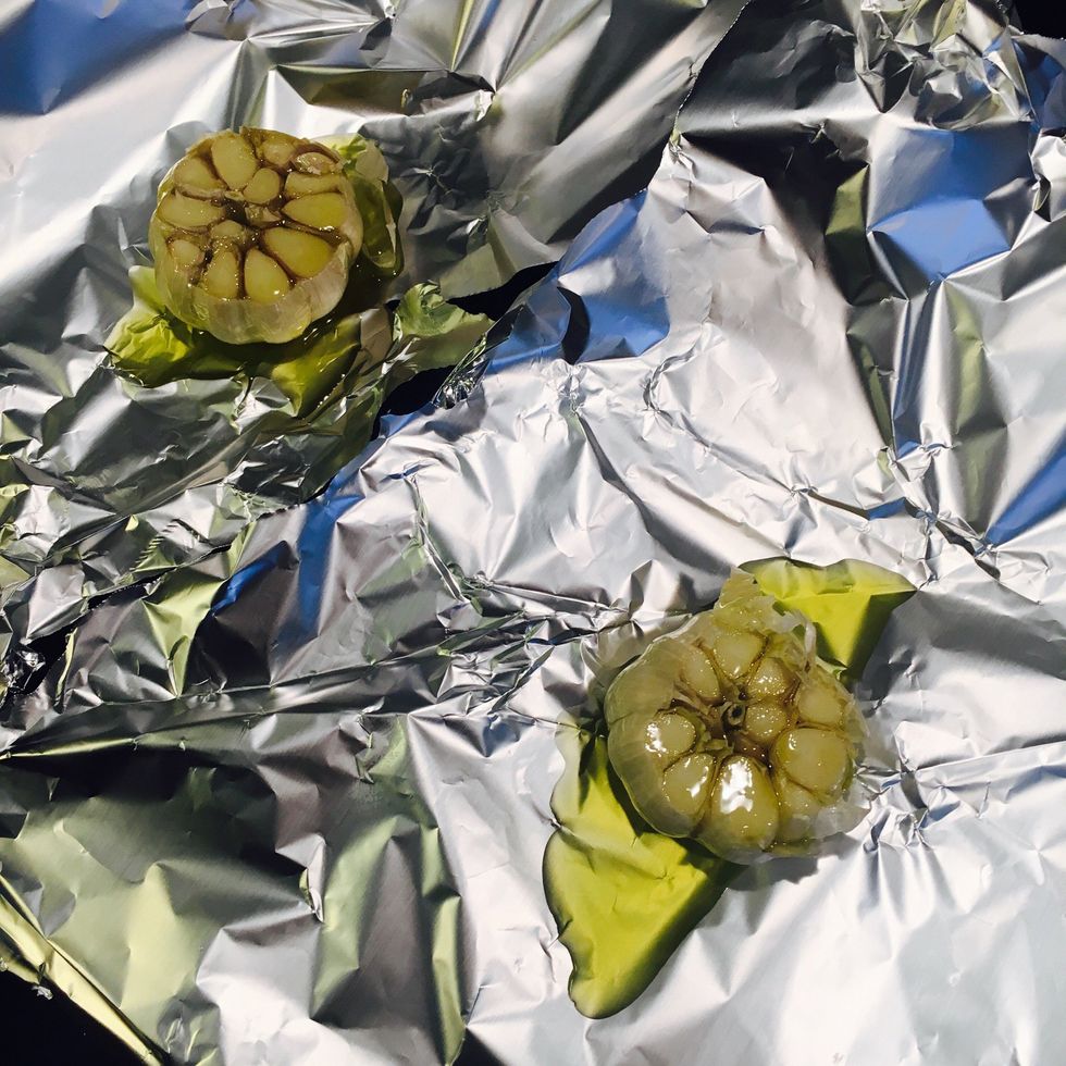 Cut the top off the garlic. Put on one piece of baking foil each. Drizzle with olive oil.