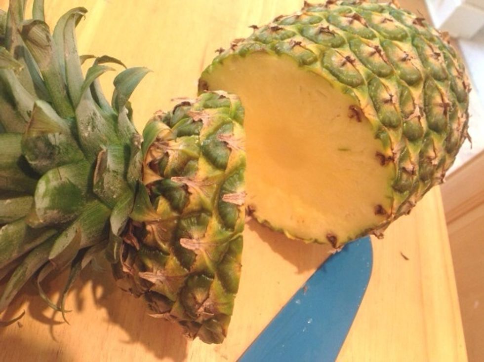 Cut the top off the pineapple making sure to leave about 1-1/2\u2033 of flesh below the leaves. Do no throw away the top\u2014more on this later.