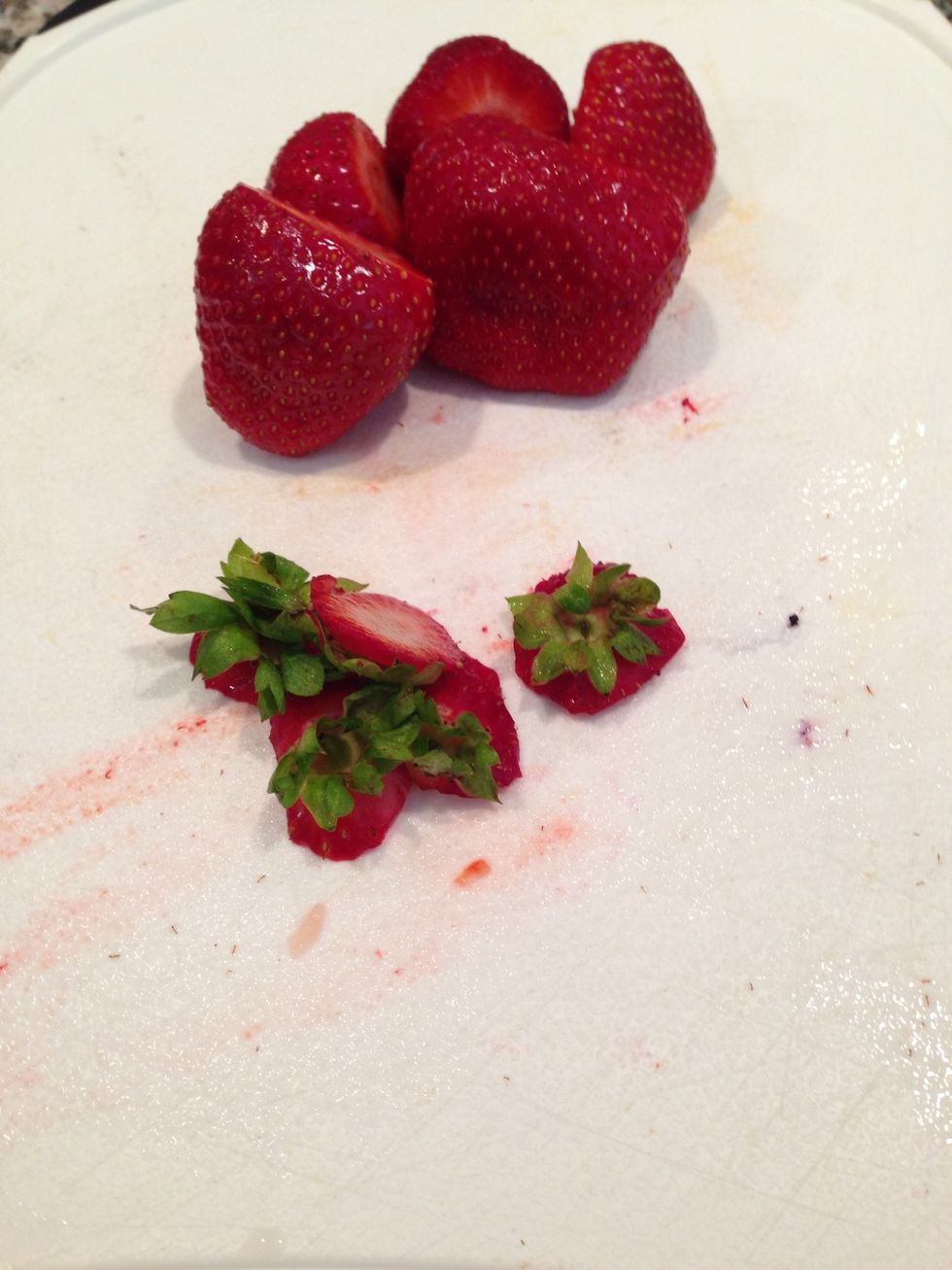 Cut the tops off of the strawberries and add them to the blender \ud83c\udf53