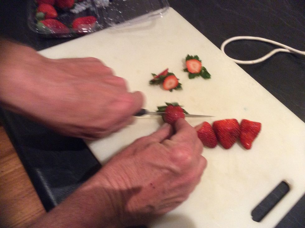 Cut the tops off the strawberries