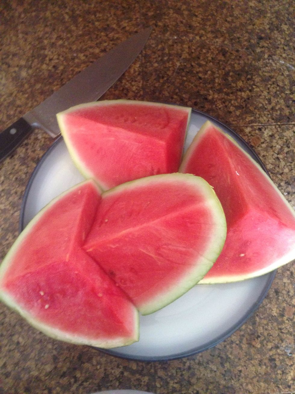 Cut the watermelon into quarters