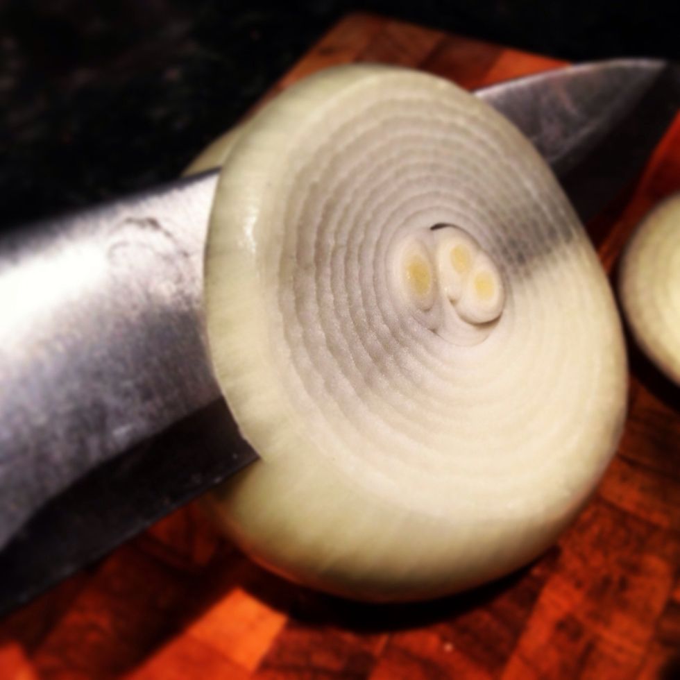 Cut the whole onion into medium slices, if they're too thin they will burn quickly and if they're too thick they won't cook all the way through.