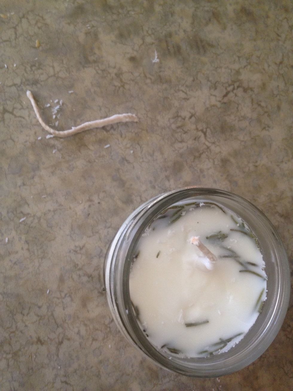 Cut the wick about a half inch from the top of the candle.