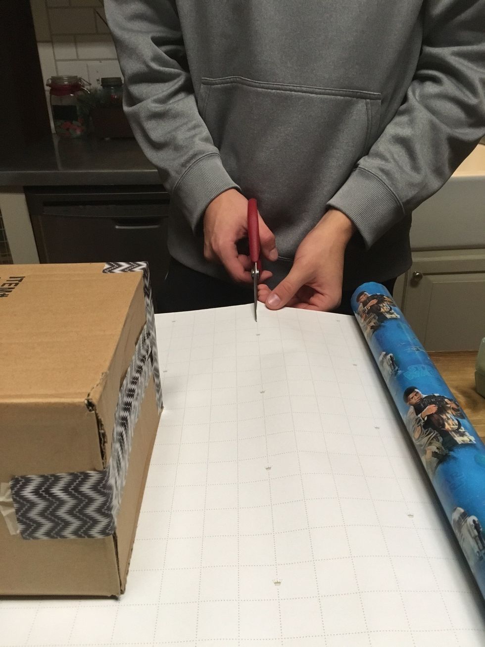 Cut the wrapping paper at the desired width. Make sure it's even on each side for the best result.