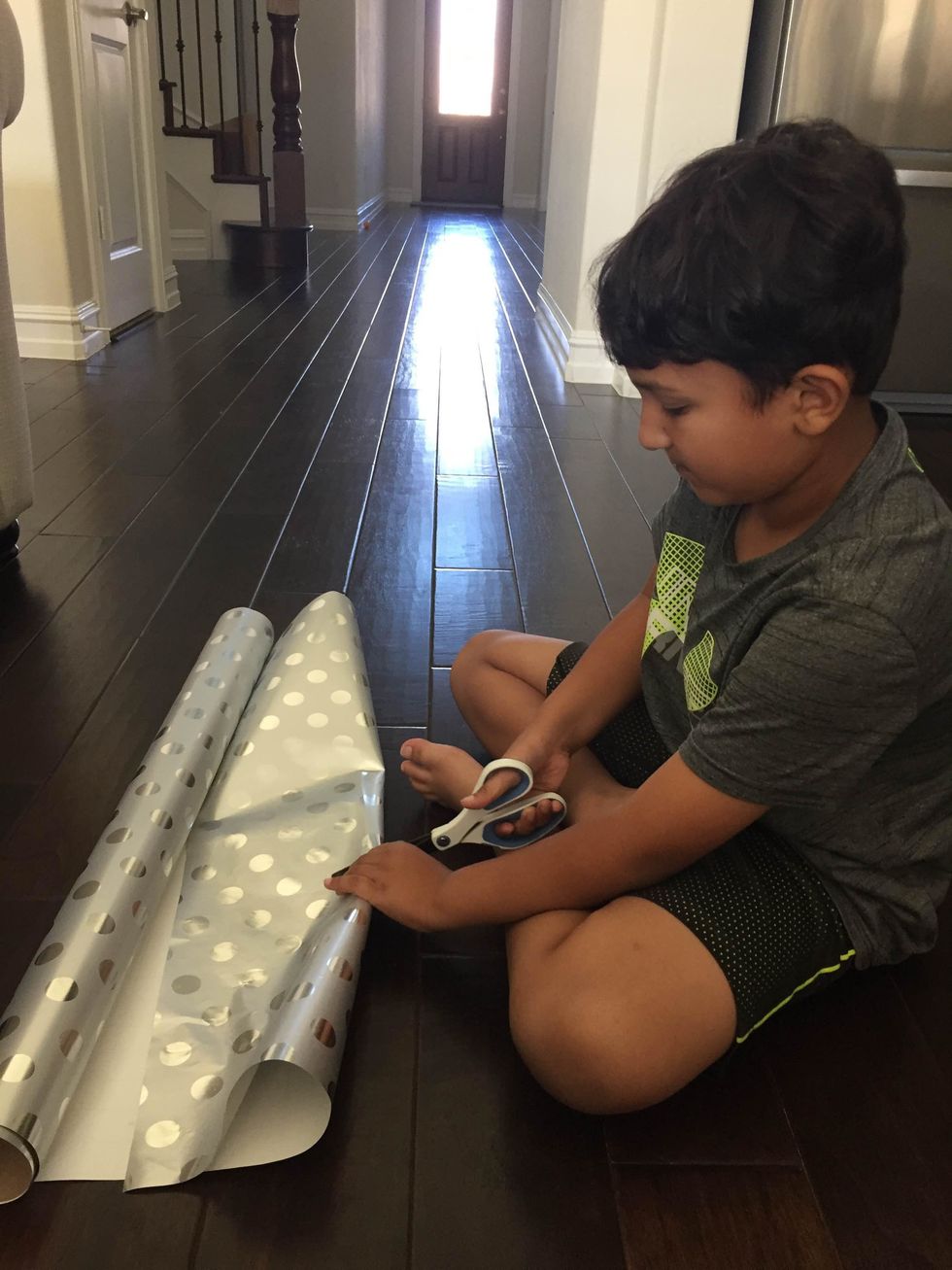 Cut the wrapping paper for the gift.