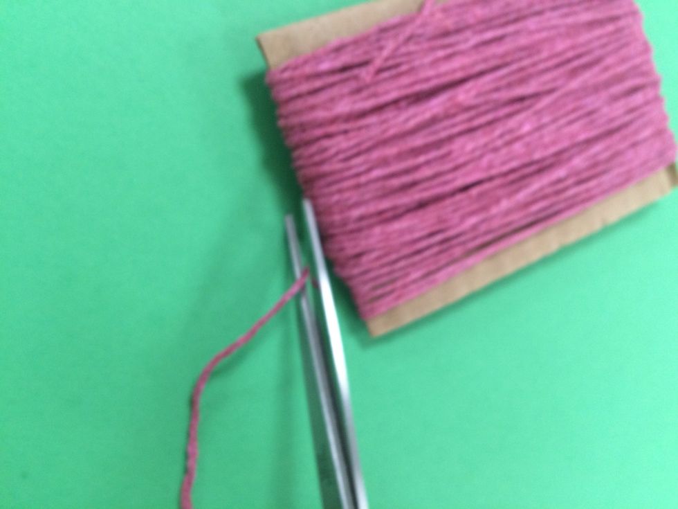 Cut the yarn close to the edge of the cardboard.