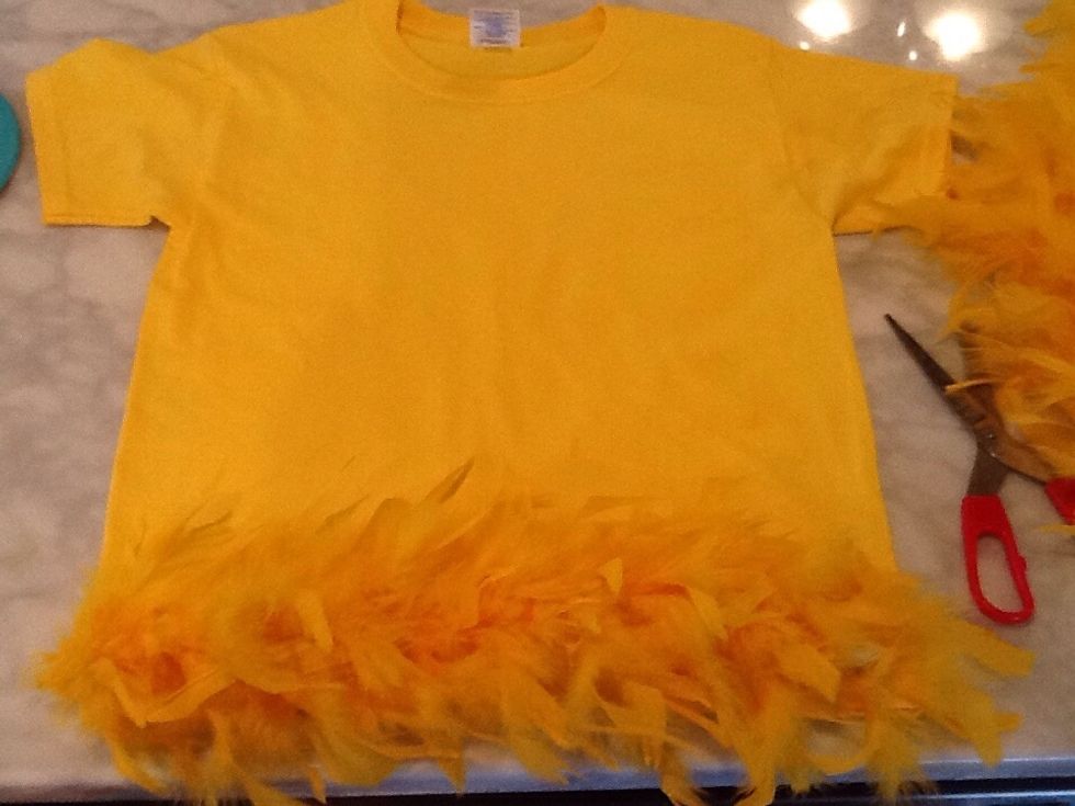 Cut the Yellow Boa to the width of the shirt and hot glue down in several places.
