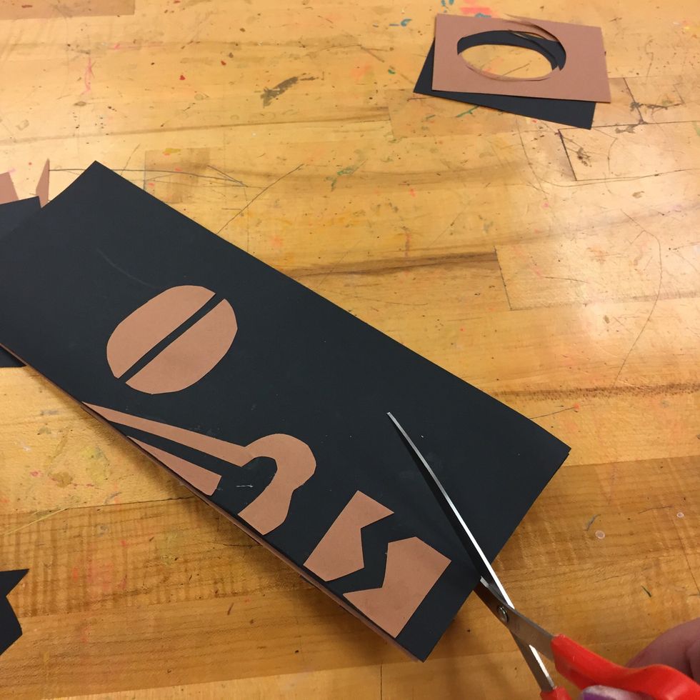 Cut through both sides to create the mask shape.